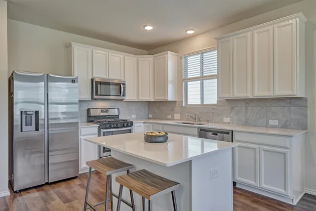 a kitchen with a sink stove and refrigerator