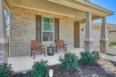 a view of a patio with chairs and table in a patio