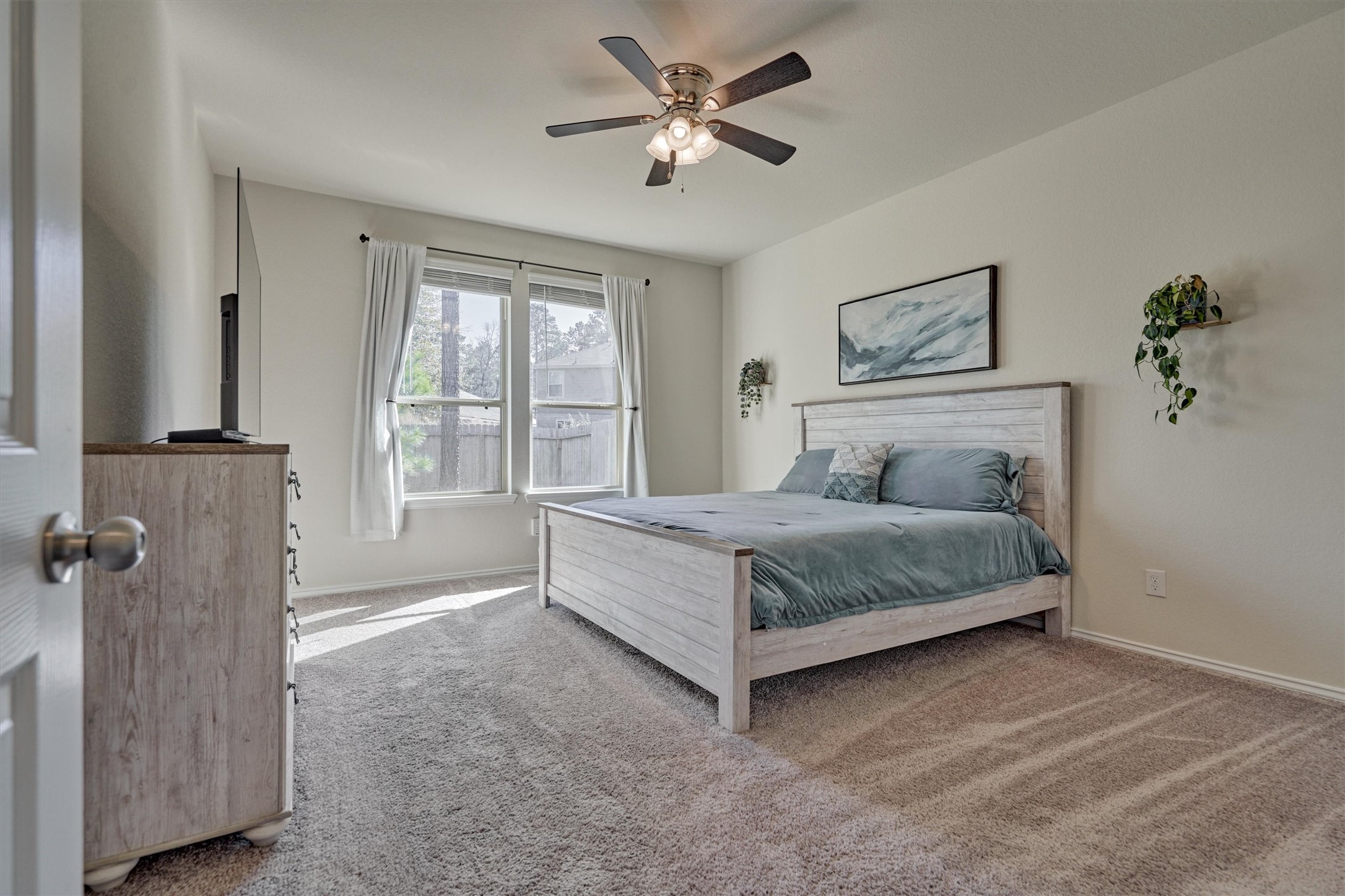 4417 Longleaf Timbers Court Conroe, TX 77304 - Photo 22 of 30 a bedroom with a bed and a painting on the wall