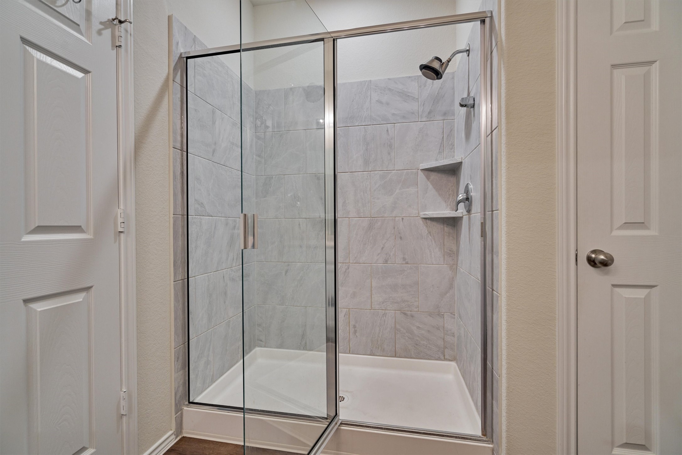 4417 Longleaf Timbers Court Conroe, TX 77304 - Photo 25 of 30 a bathroom with a glass shower door