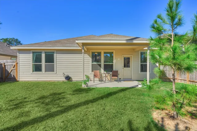 a view of a chair and table in front of a house