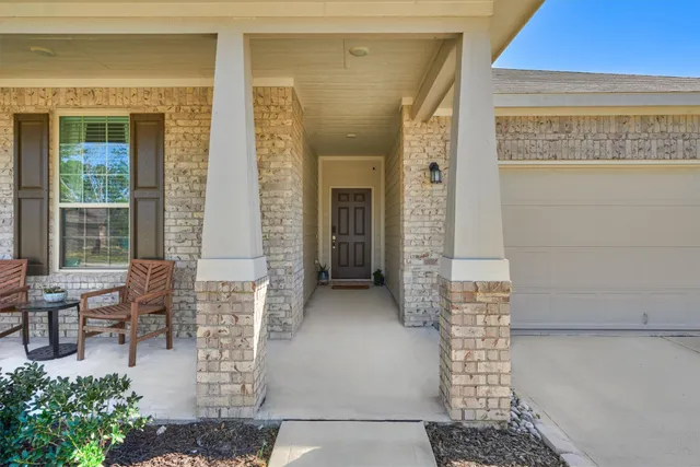 a view of a hallway with a livingroom and furniture