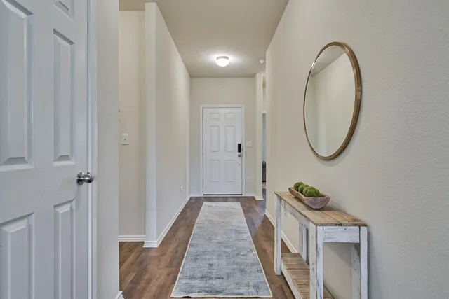 a bedroom with furniture and a flat screen tv