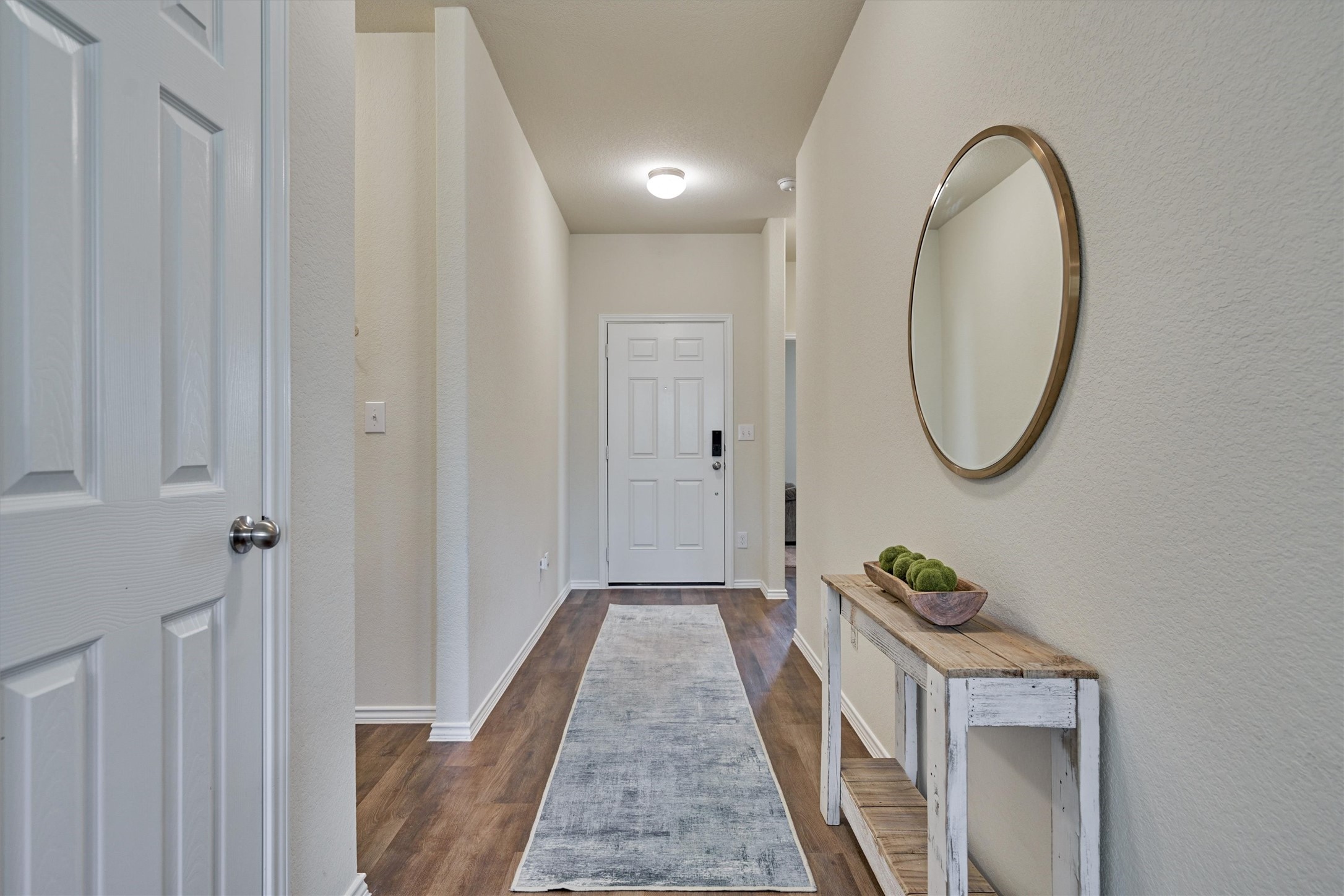 4417 Longleaf Timbers Court Conroe, TX 77304 - Photo 5 of 30 a view of a hallway with wooden floor and door