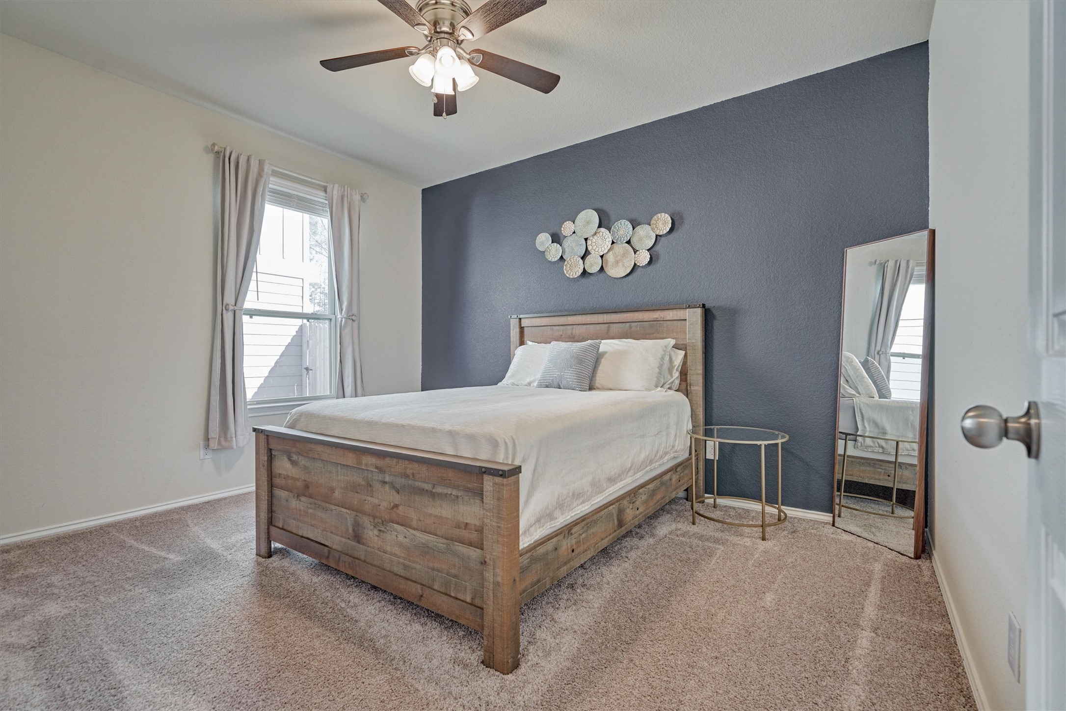 4417 Longleaf Timbers Court Conroe, TX 77304 - Photo 9 of 30 a bedroom with a large bed and a chandelier