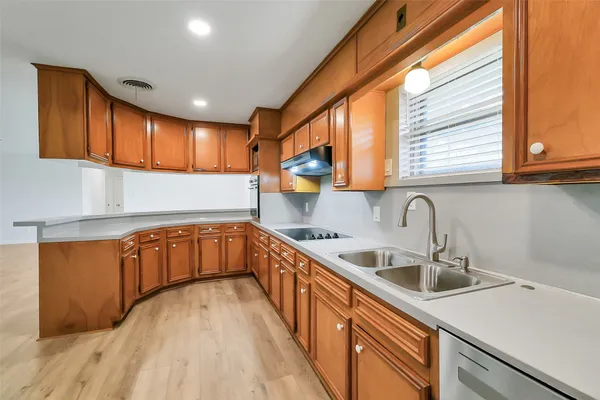 a kitchen with stainless steel appliances granite countertop a sink a stove and a microwave oven