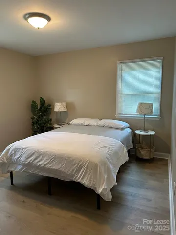 a bedroom with a bed and a mirror