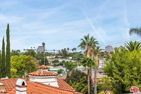 a view of a house with a backyard and a garden