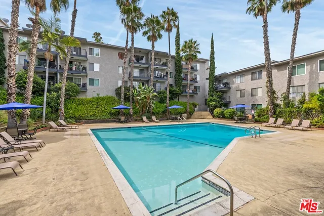 a view of car parked on the side of a street
