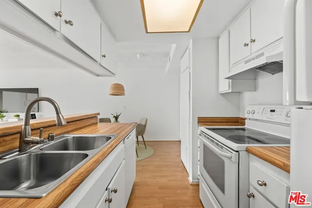 a kitchen that has a sink and a stove