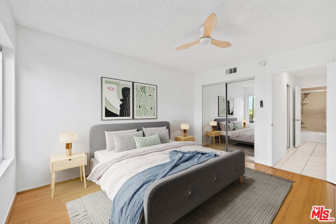 1517 East Garfield Avenue, Unit 23 Glendale, CA 91205 - Photo 7 of 14 a spacious bedroom with a bed and wooden floor