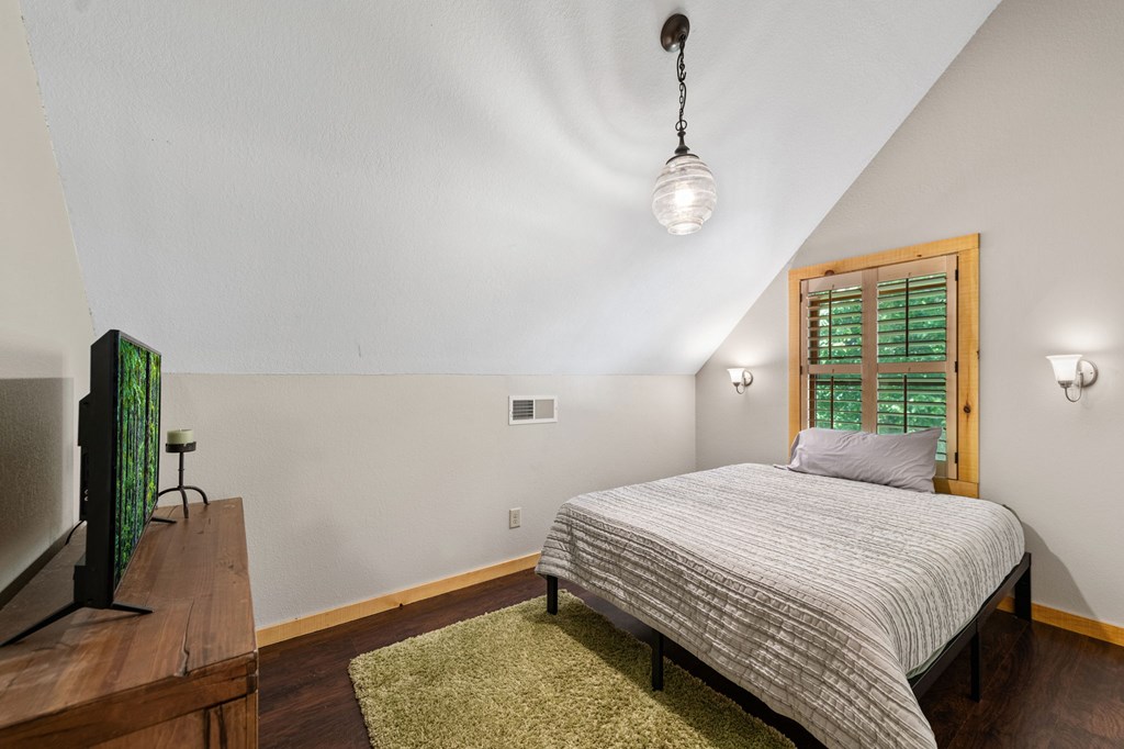 479 Big Timber Road Mineral Bluff, GA 30559 - Photo 27 of 60 a bedroom with a bed window and a flat screen tv