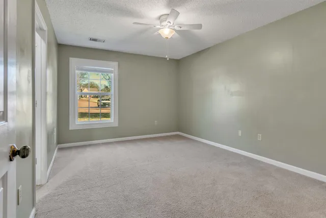 a spacious bathroom with a granite countertop sink and a mirror