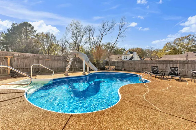 a view of a swimming pool with a patio