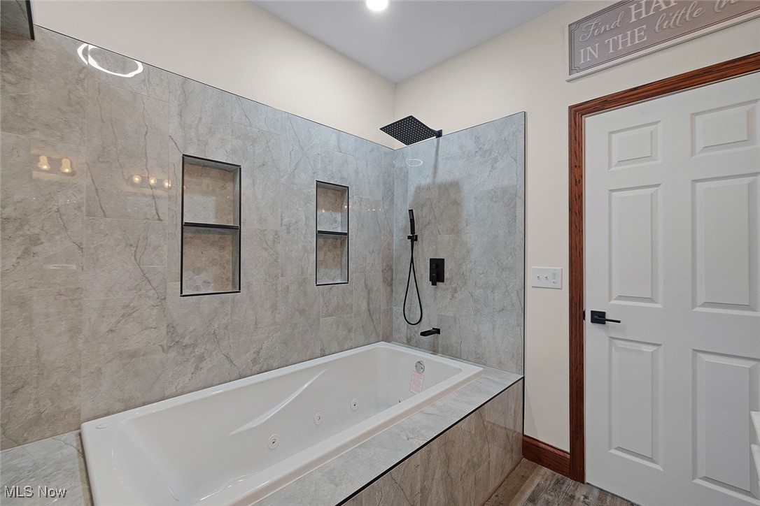 11794 Vermilion Road Oberlin, OH 44074 - Photo 13 of 34 Full bath featuring a combined bath / shower with jetted tub and wood finished floors