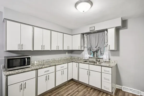 a kitchen with a sink stove and cabinets
