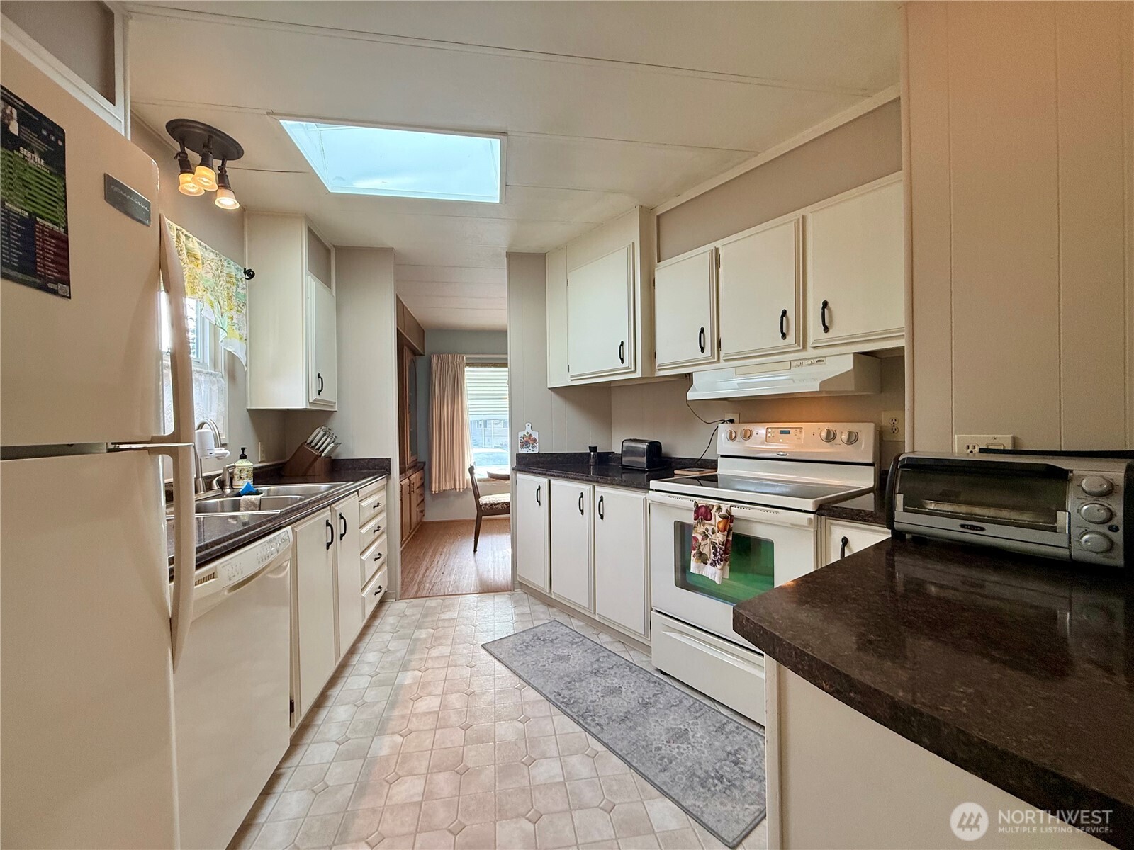 11622 Silver Lake Road, Unit 55 Everett, WA 98208 - Photo 7 of 21 a kitchen with stainless steel appliances granite countertop a stove a sink dishwasher and a refrigerator