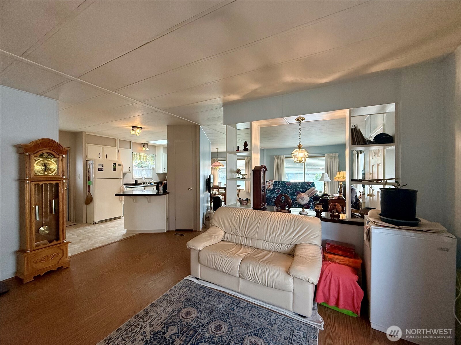 11622 Silver Lake Road, Unit 55 Everett, WA 98208 - Photo 9 of 21 a living room with furniture a flat screen tv and kitchen view