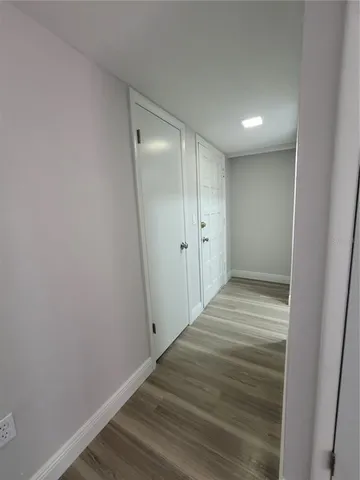 a view of a hallway with wooden floor