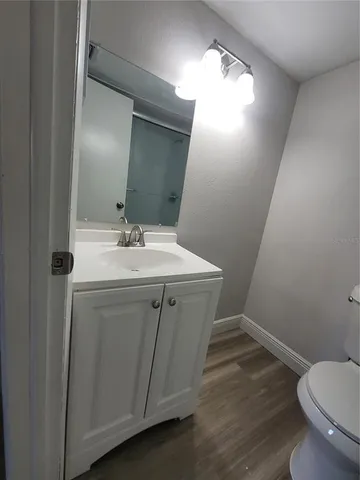 a bathroom with a sink toilet and mirror