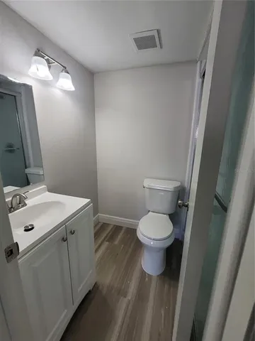 a white toilet sitting next to a bathroom sink