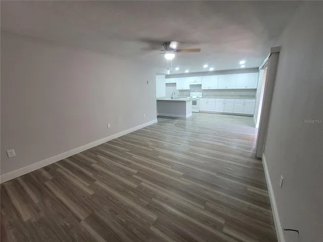 a view of a room with wooden floor