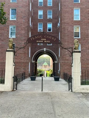 a brick building with a bench and a sink