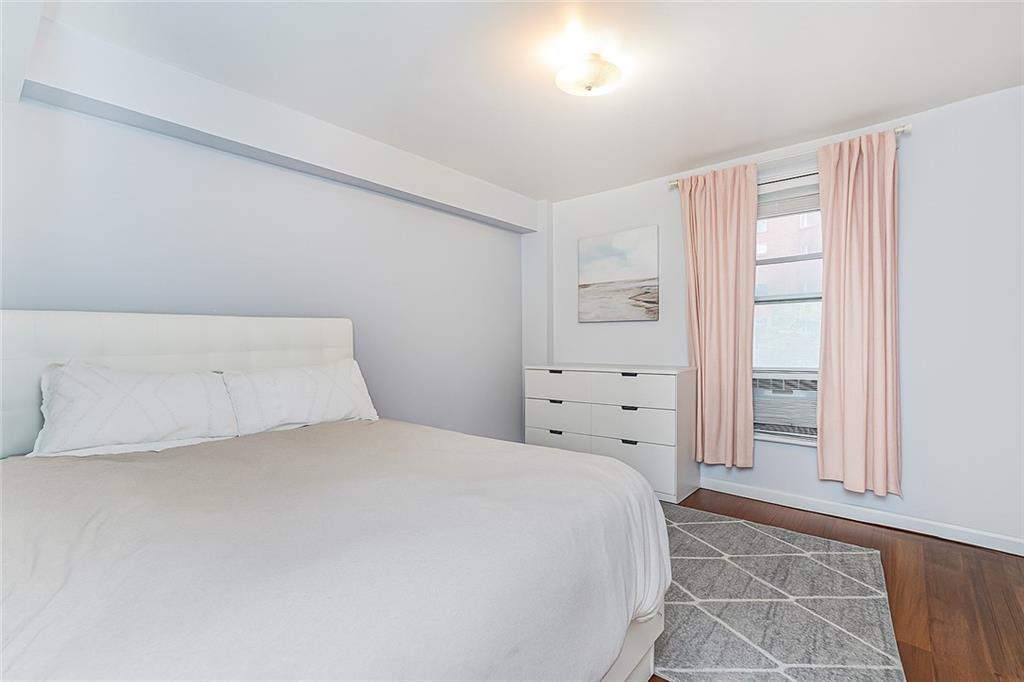 191 73rd Street, Unit 219 Brooklyn, NY 11209 - Photo 4 of 9 a bedroom with a bed and a walk in closet