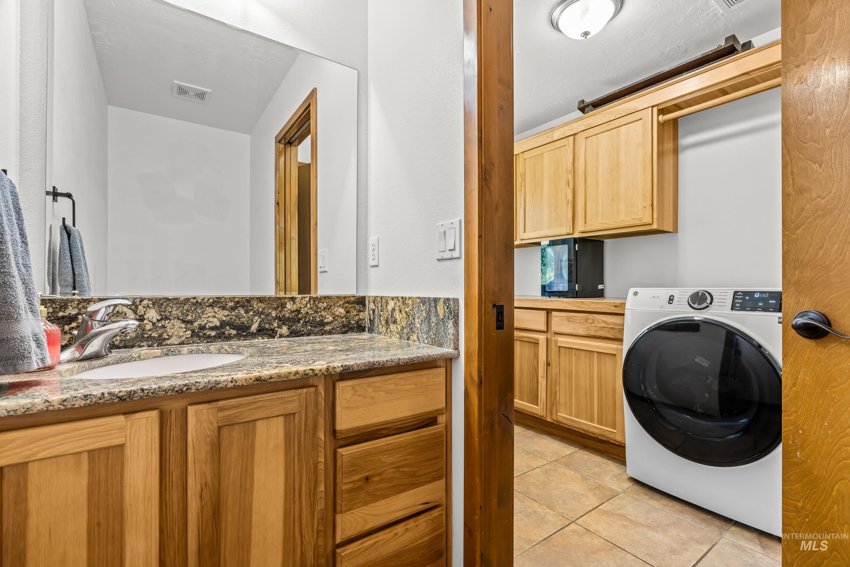92 Cruickshank Road Horseshoe Bend, ID 83629 - Photo 42 of 50 Vanity with a granite countertop, undermount sink, and wood cabinetry