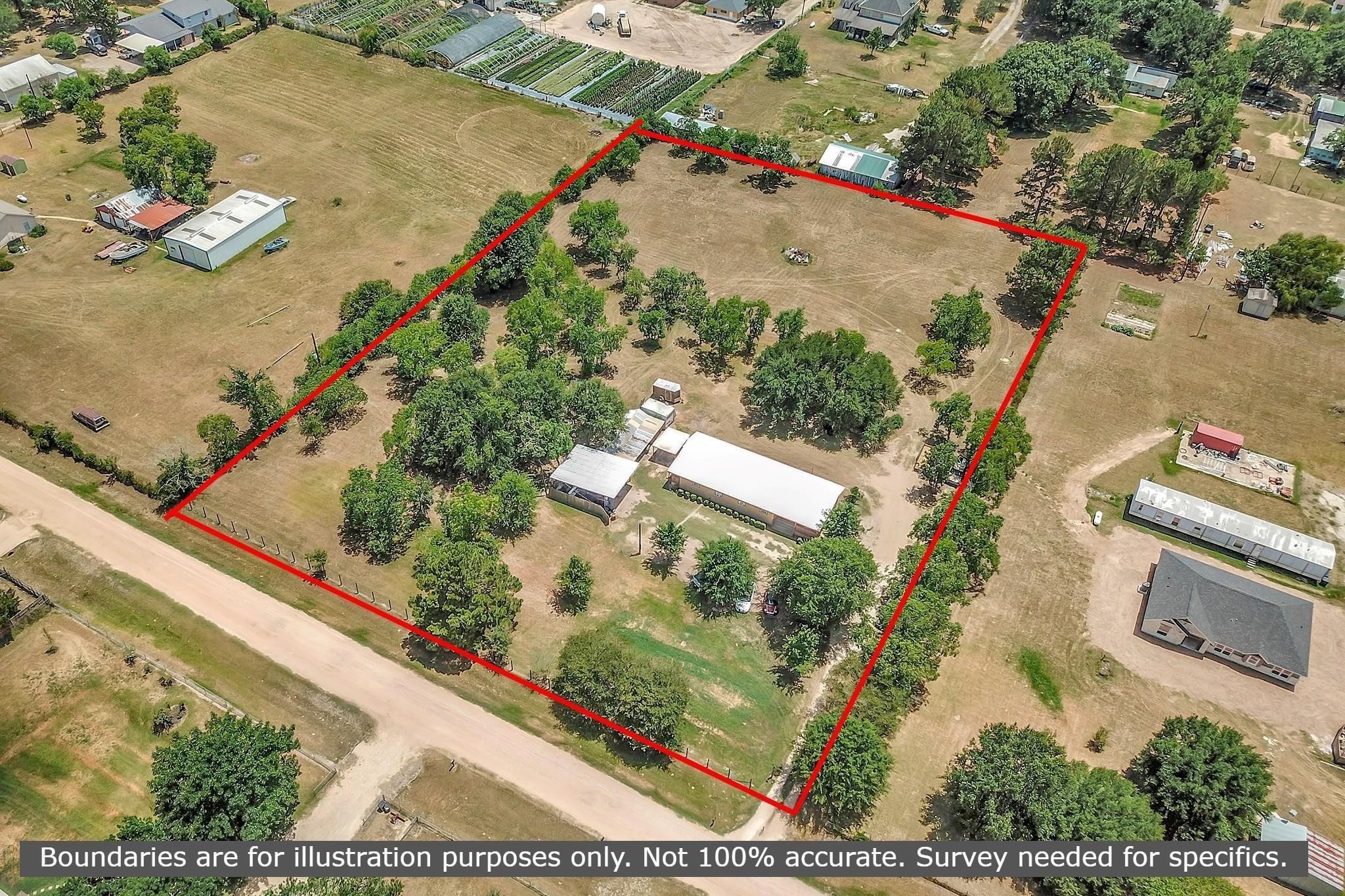 29115 Cherokee Lane Waller, TX 77484 - Photo 44 of 50 This aerial photo shows a spacious property outlined in red, featuring a mix of open land and mature trees. There are several structures, including a large white building, situated on a dirt road. The surrounding area is rural, with neighboring properties visible. Ideal for those seeking privacy and space.