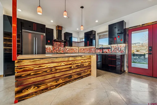 a view of kitchen with stainless steel appliances granite countertop a stove and a refrigerator