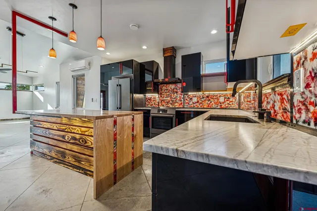 a kitchen with stainless steel appliances a sink and a refrigerator