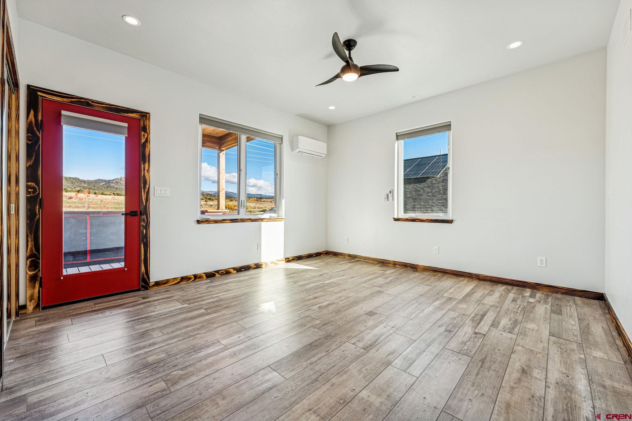 227 Sage View Street Durango, CO 81301 - Photo 23 of 35 a view of an empty room with wooden floor and a window