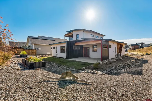 a view of a big house with a yard