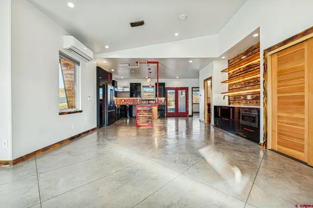 a view of a livingroom with furniture and kitchen view