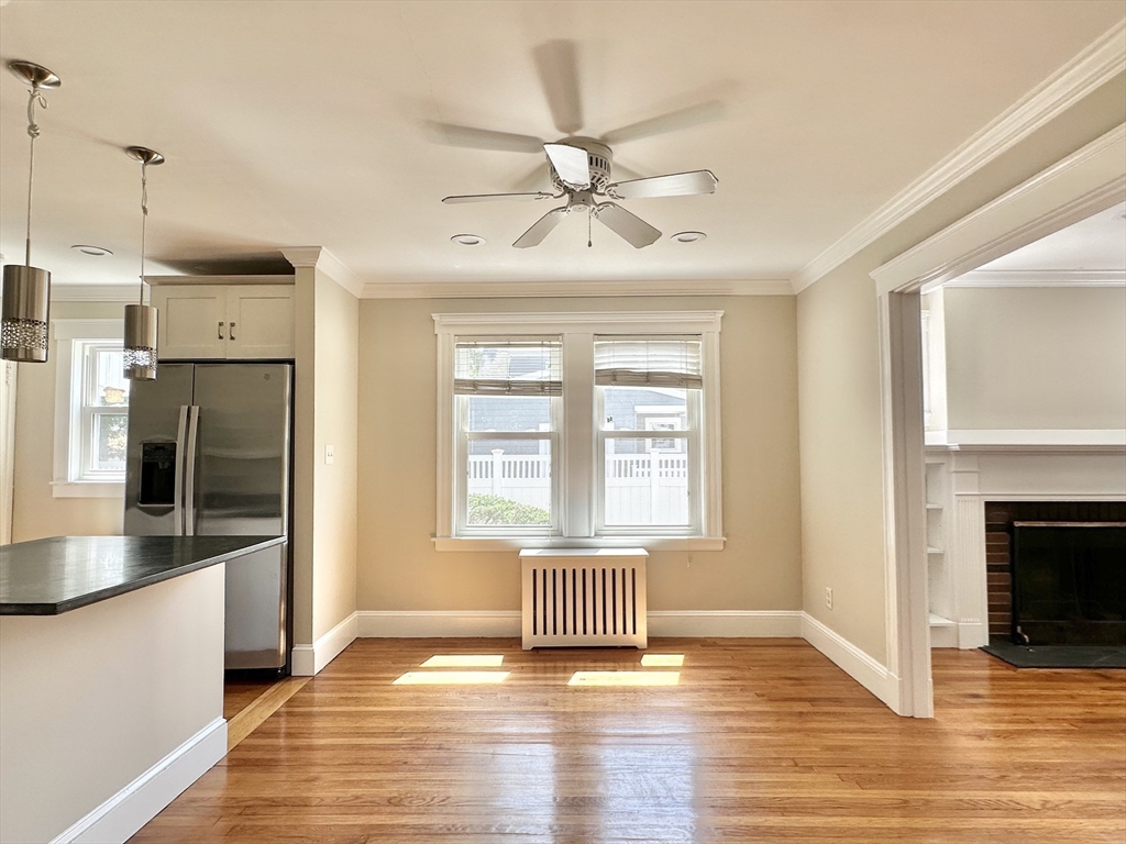 8 A Mellon Road Wellesley, MA 02482 - Photo 5 of 22 a view of an empty room with window and wooden floor