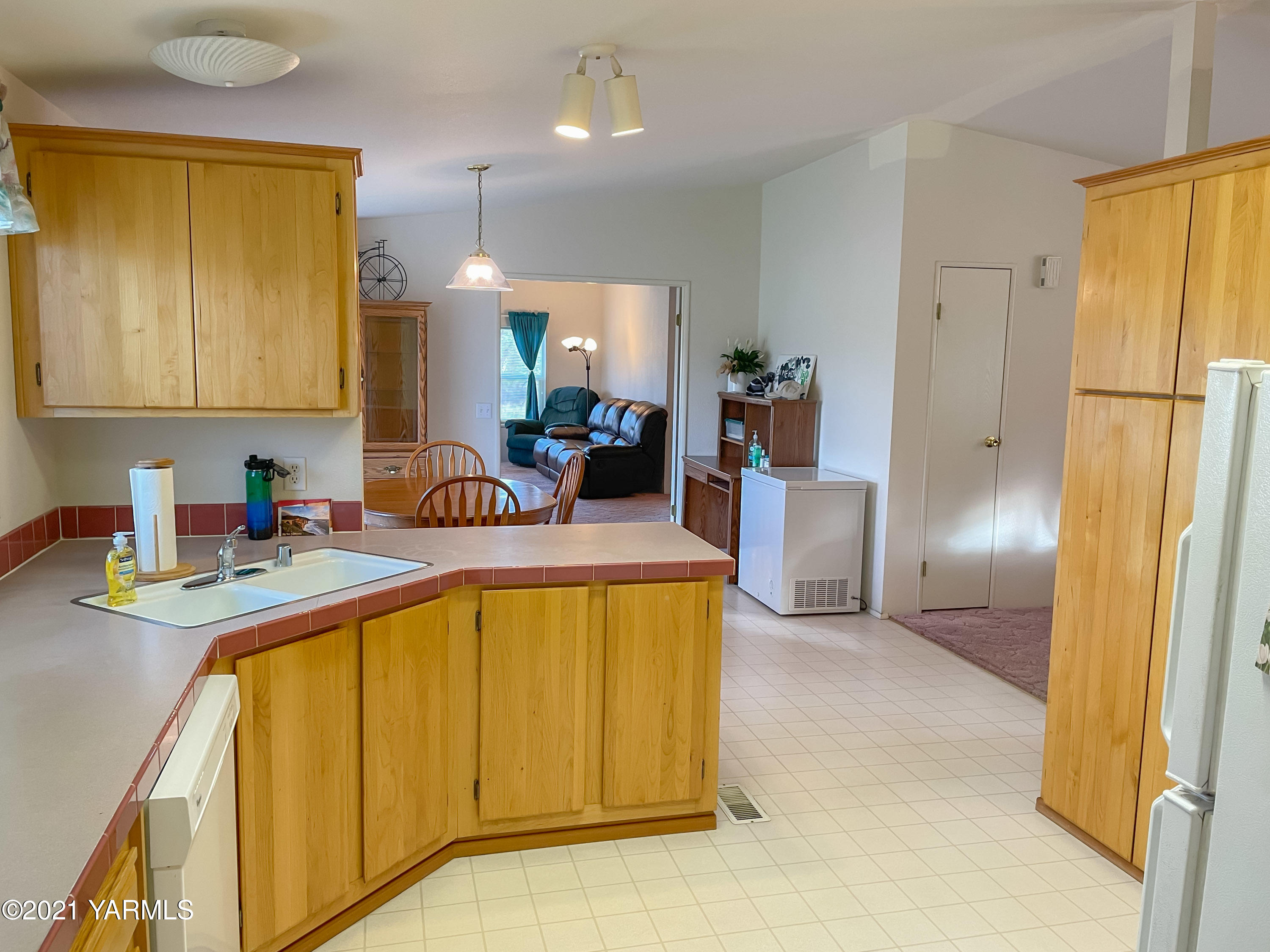 11806 Postma Road Moxee, WA 98936 - Photo 5 of 24 a large kitchen with a refrigerator a sink and dishwasher