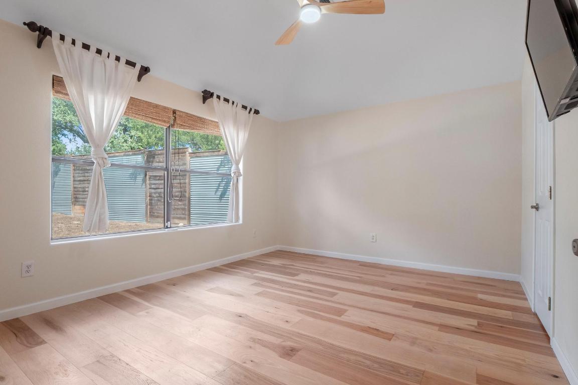 10213 Thomas Lane Dripping Springs, TX 78620 - Photo 14 of 40 a view of wooden floor and windows in a room