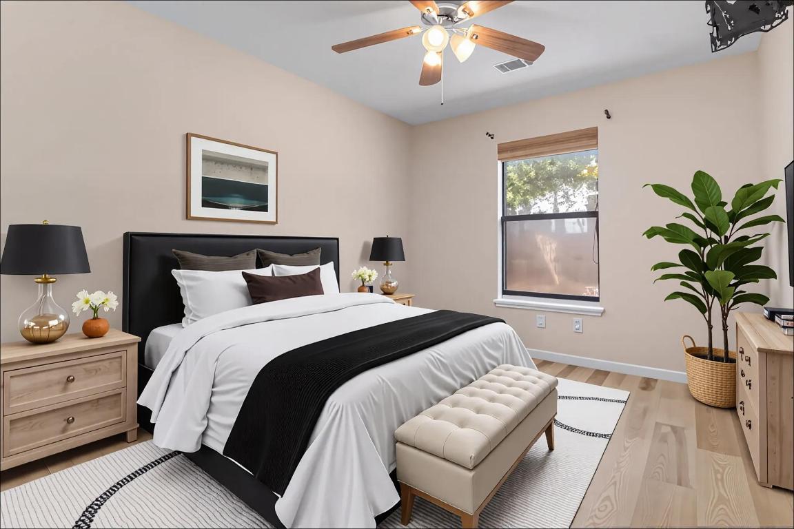 10213 Thomas Lane Dripping Springs, TX 78620 - Photo 23 of 40 a bedroom with a bed and a potted plant