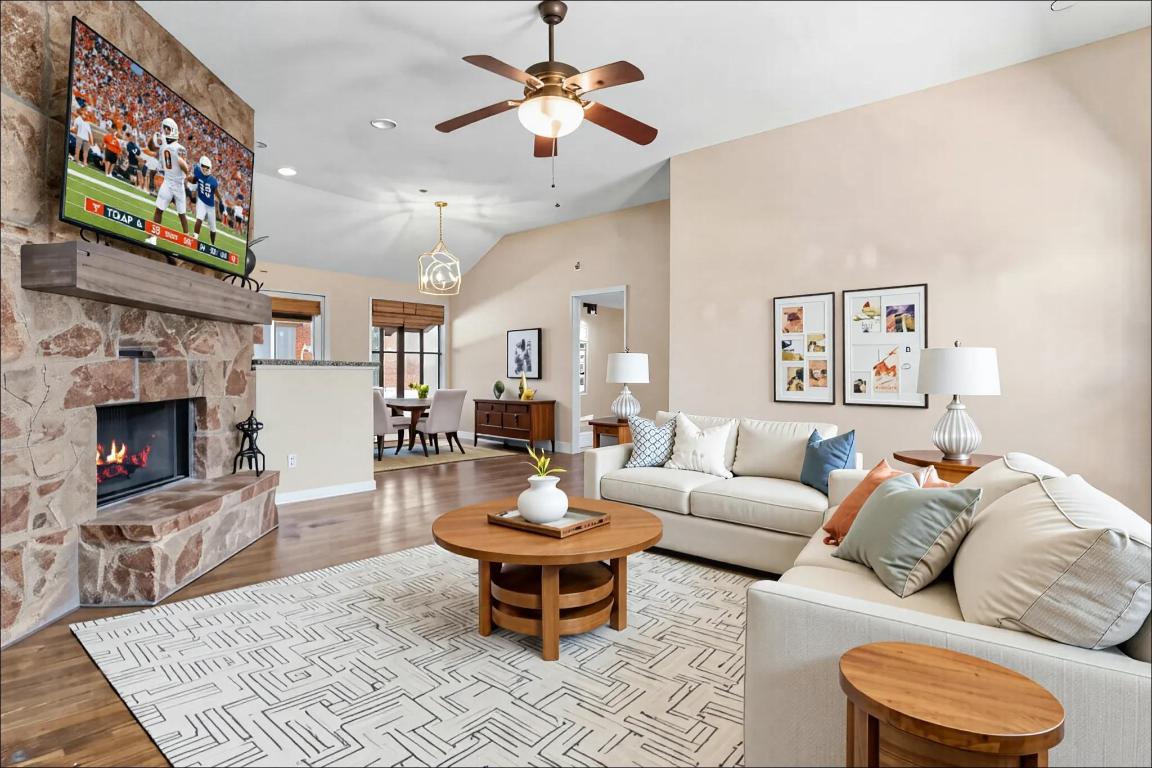 10213 Thomas Lane Dripping Springs, TX 78620 - Photo 8 of 40 a living room with furniture a fireplace and a flat screen tv