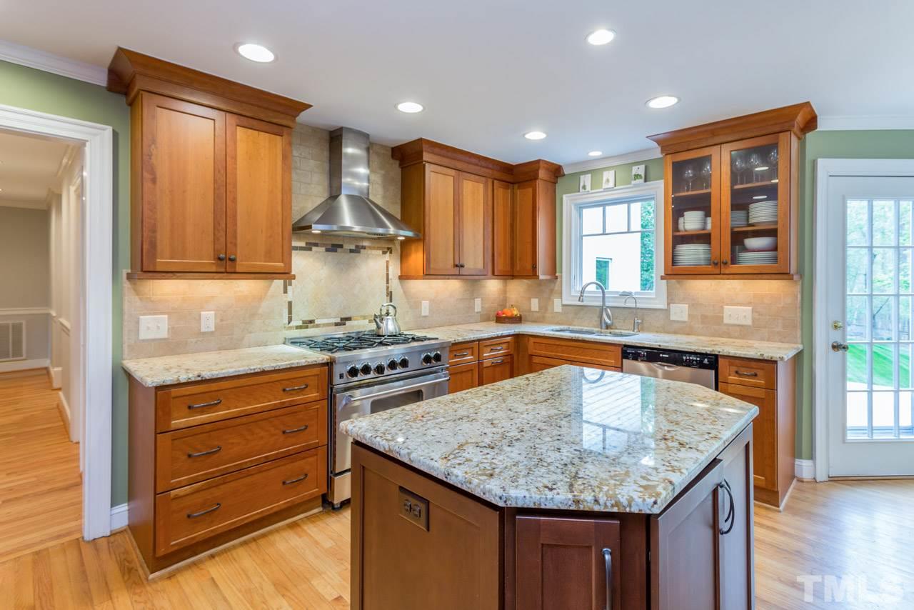 905 Brookfield Road Raleigh, NC 27615 - Photo 13 of 25 a kitchen with stainless steel appliances granite countertop stove top oven and cabinets