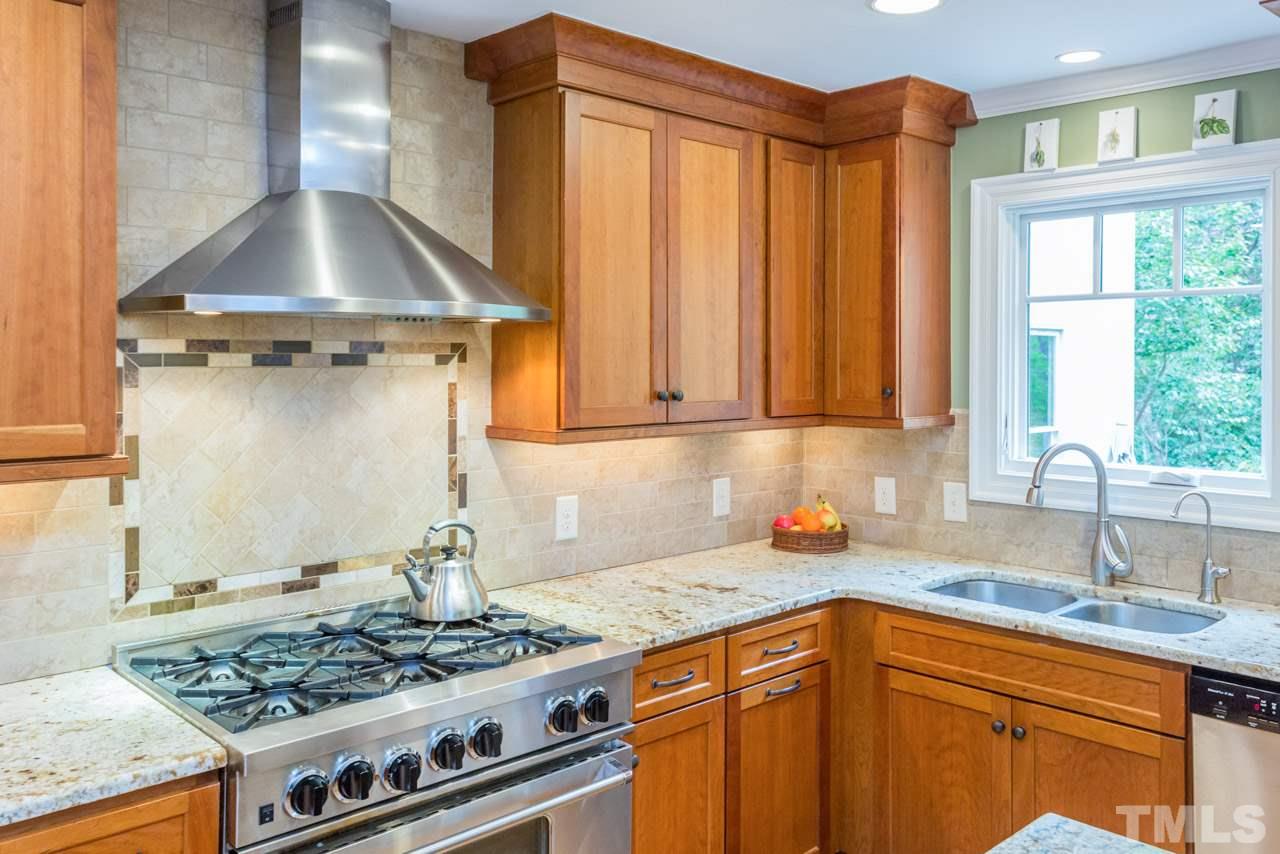 905 Brookfield Road Raleigh, NC 27615 - Photo 14 of 25 a kitchen with stainless steel appliances granite countertop a sink stove and cabinets