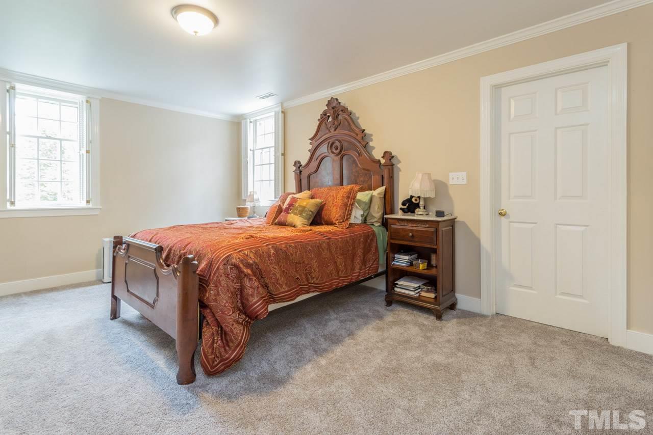 905 Brookfield Road Raleigh, NC 27615 - Photo 16 of 25 a bedroom with a bed and a window