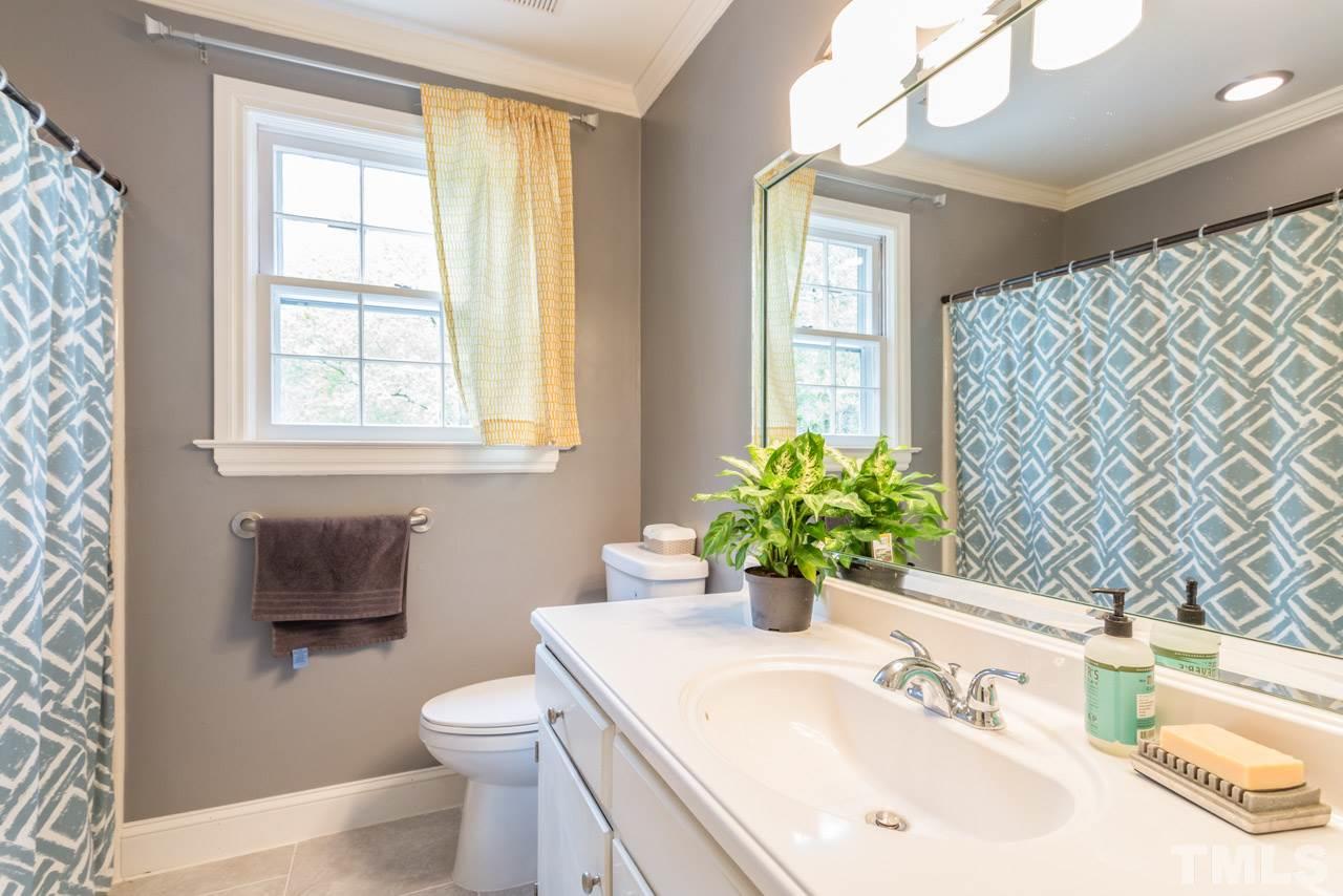 905 Brookfield Road Raleigh, NC 27615 - Photo 17 of 25 a bathroom with a sink a toilet and mirror