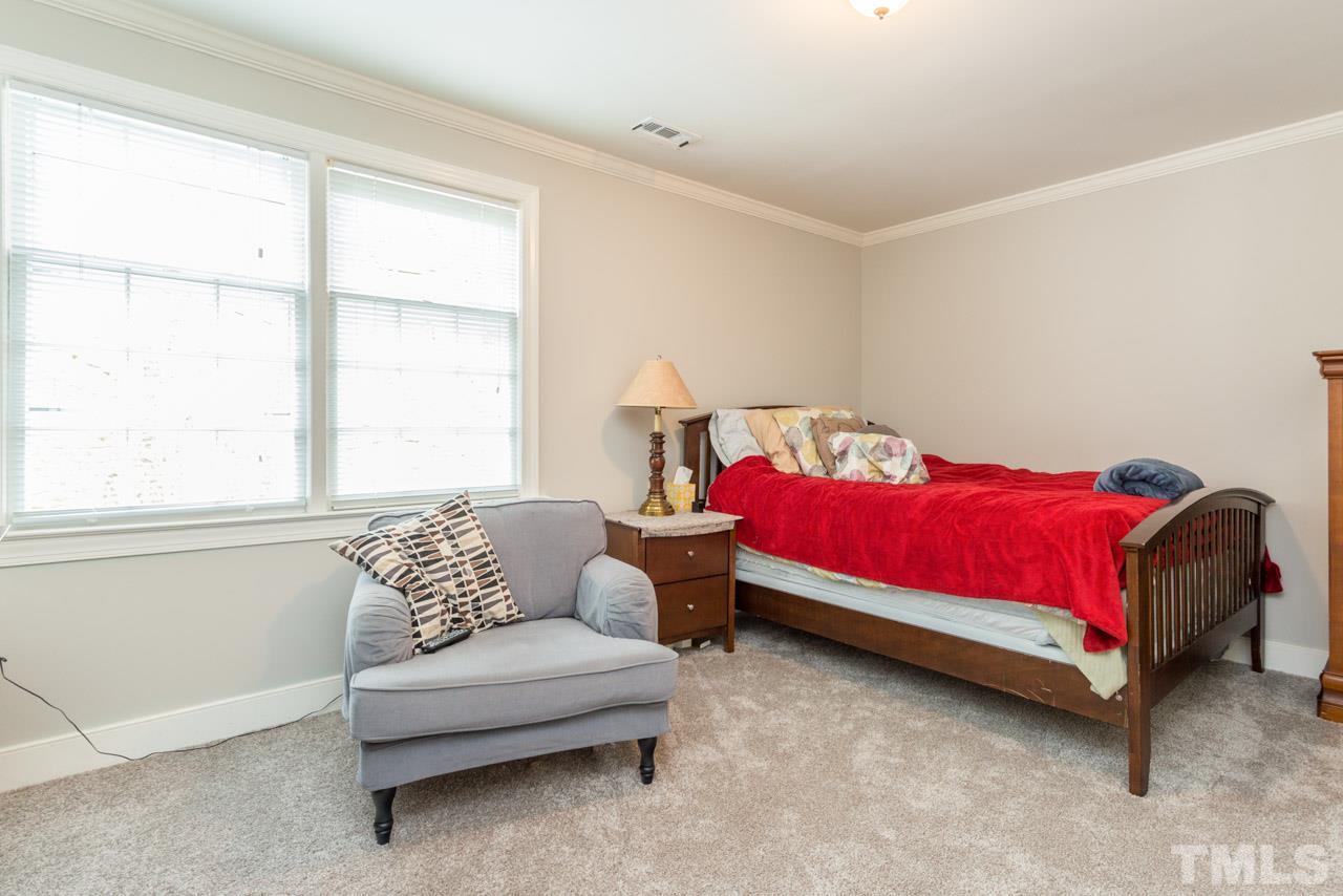 905 Brookfield Road Raleigh, NC 27615 - Photo 19 of 25 a bedroom with furniture and a large window