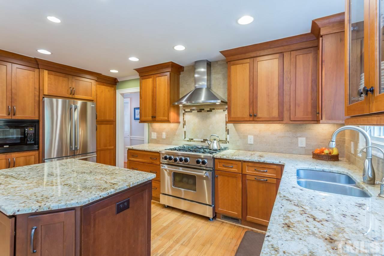 905 Brookfield Road Raleigh, NC 27615 - Photo 3 of 25 a kitchen with stainless steel appliances granite countertop a stove a sink dishwasher and a refrigerator with wooden floor