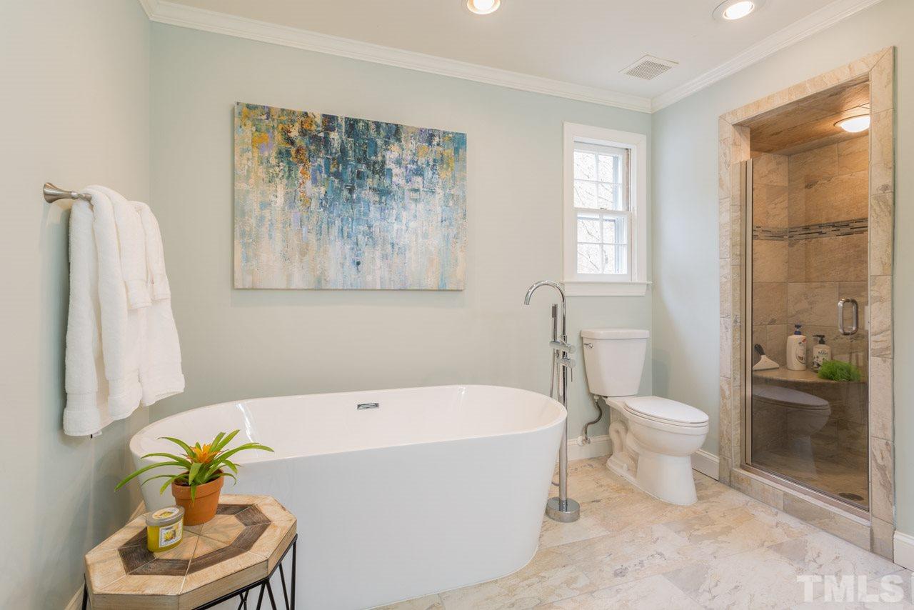 905 Brookfield Road Raleigh, NC 27615 - Photo 4 of 25 a white bath tub sitting next to a white toilet and a shower
