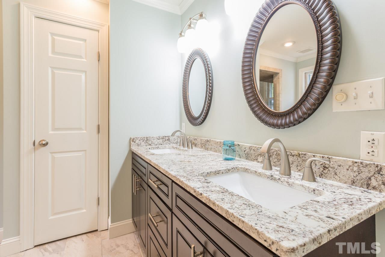 905 Brookfield Road Raleigh, NC 27615 - Photo 5 of 25 a bathroom with a granite countertop sink and a mirror