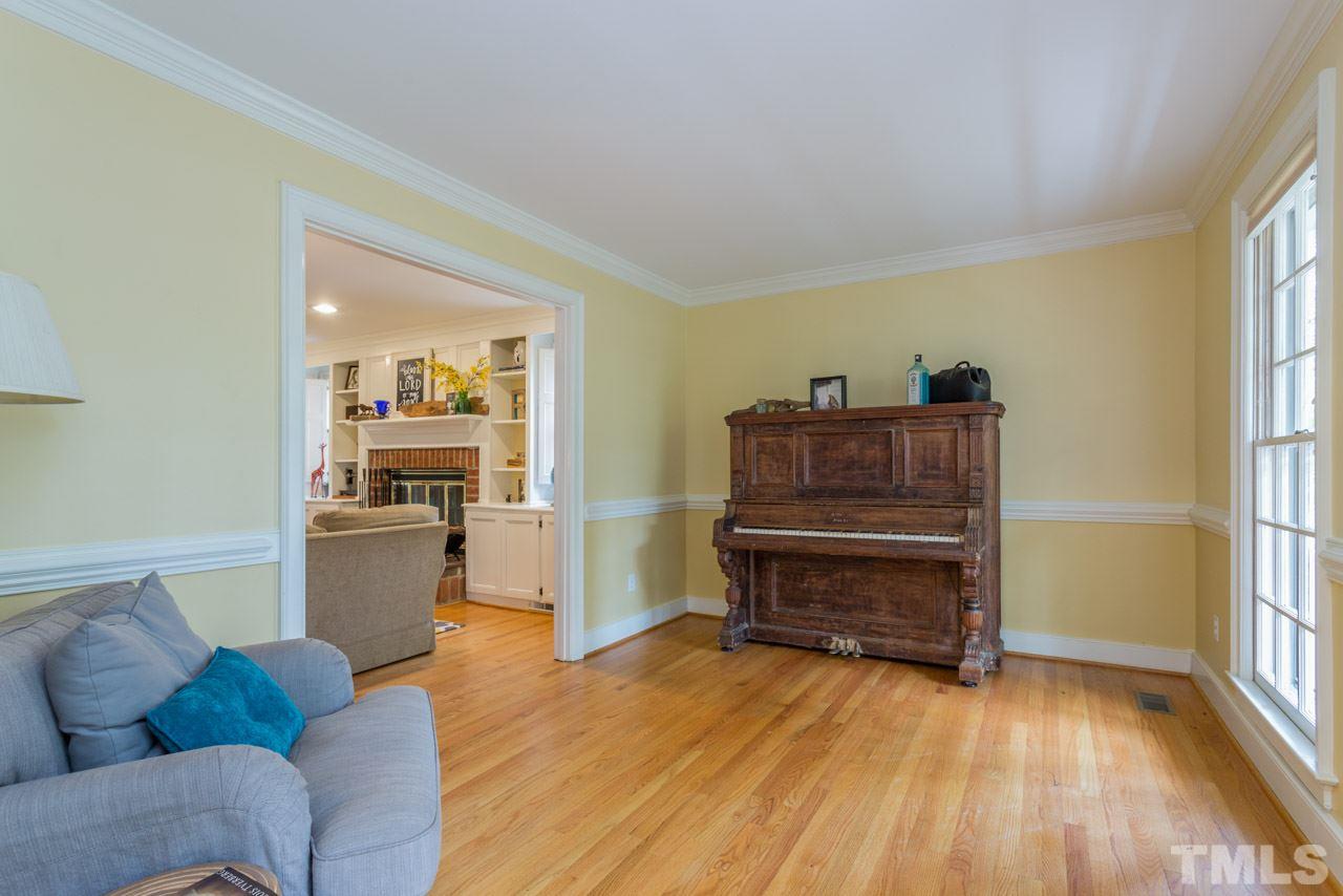 905 Brookfield Road Raleigh, NC 27615 - Photo 8 of 25 a living room with furniture and a wooden floor