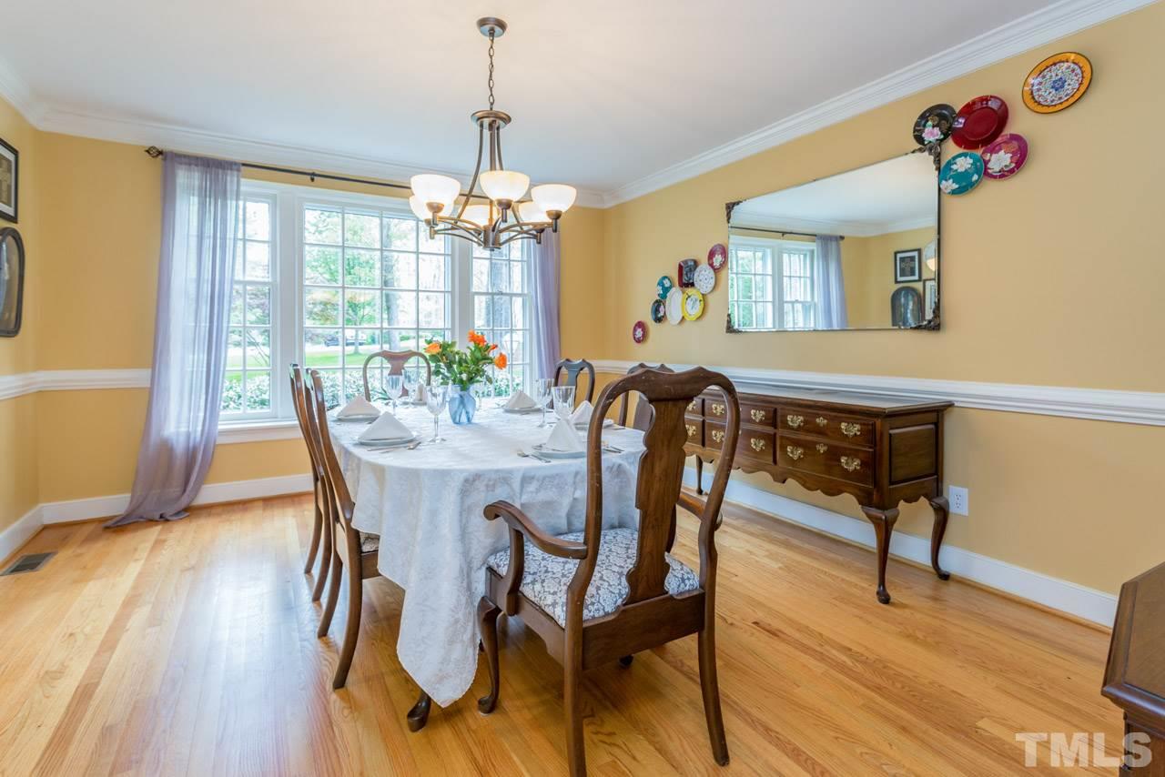 905 Brookfield Road Raleigh, NC 27615 - Photo 9 of 25 a view of a dining room with furniture wooden floor and chandelier